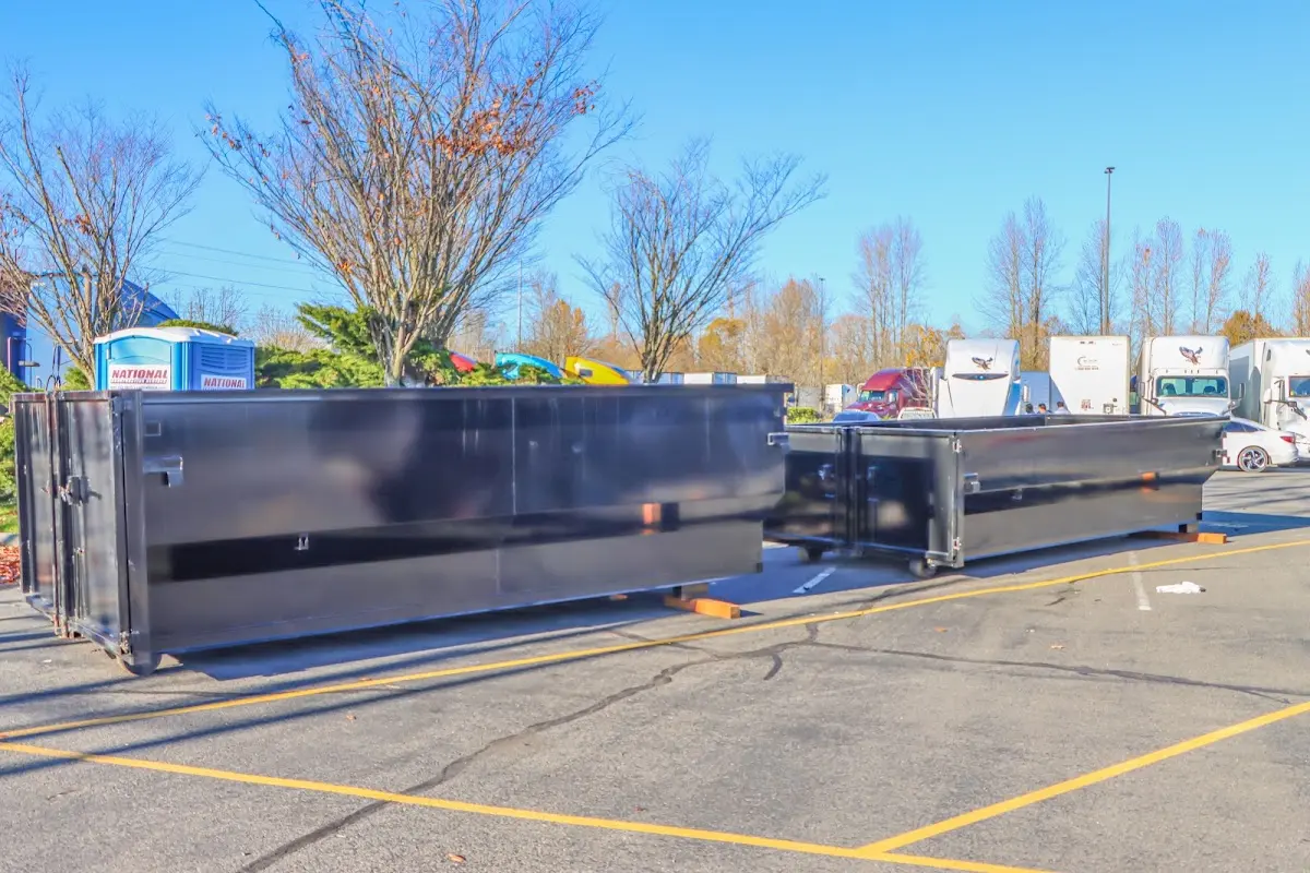 Professional dumpster rental service with roll-off container on residential driveway in Girard